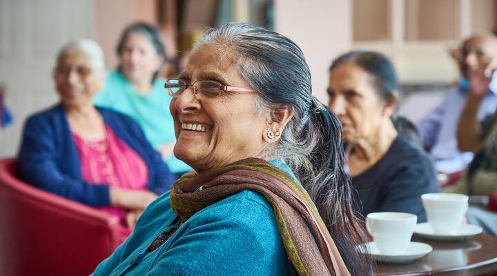 Customer smiling which at an event with tea and coffee