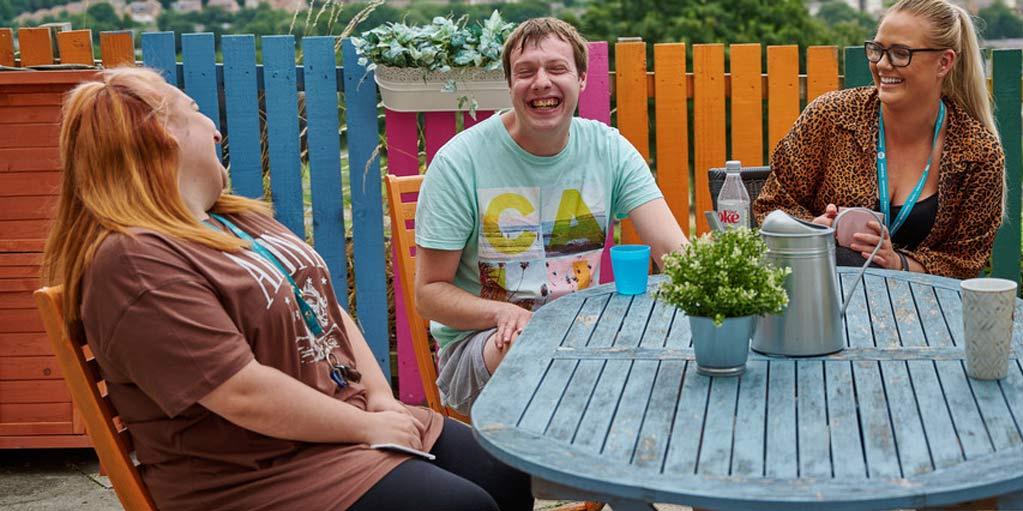 Customers and colleague having  laugh in the garden. 