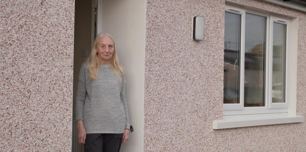 Home Group customer Queenie Fearon stood outside her retrofitted home