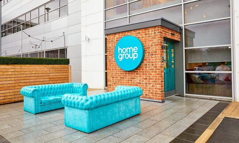 Outside of Home Group's office with teal sofas and Home Group logo